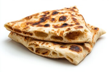A close up shot of two pieces of flatbread stacked on a white surface top