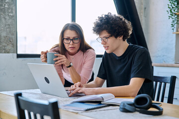 Middle aged mother and son university student, together at home
