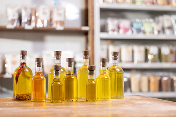 Set fresh craft oil bottles on store background. Concept eco healthy food shop