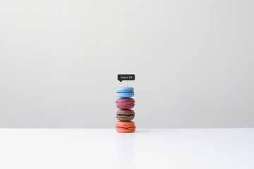 Stack of assorted Macarons (french macaroons) on a table with a select all sign