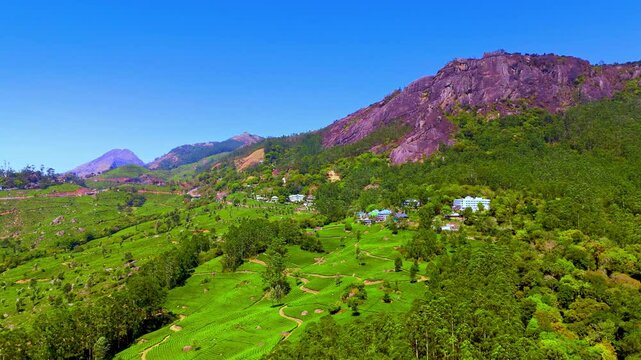 aerial view of Munnar&rsquo;s lush green hills with scattered homes