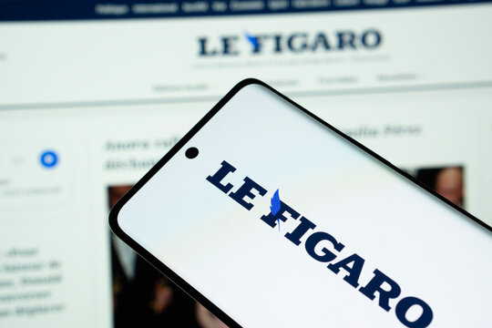 Dhaka, Bangladesh - 17 March 2025: The logo of the newspaper le figaro is displayed on a smartphone screen, and the website le figaro is visible on a computer screen in the background.
