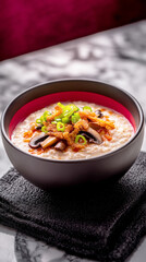 A comforting bowl of oatmeal cooked in chicken broth, enhanced with fried mushrooms and fresh green onions, perfect for a warm, hearty breakfast