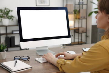 Woman working on computer at wooden desk in office. Mockup for design