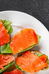 Salmon sandwich red fish seafood appetizer dish fresh tasty gourmet food background on table rustic food top view copy space pescetarian diet