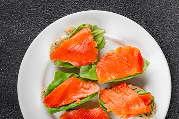 Salmon sandwich red fish seafood appetizer dish fresh tasty gourmet food background on table rustic food top view copy space pescetarian diet