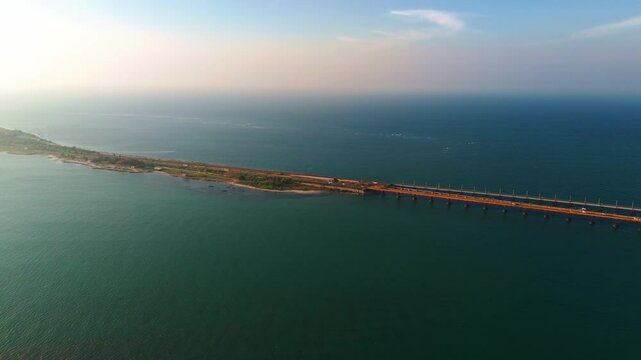 Wide drone view of Pamban Bridge Road over tranquil ocean waters