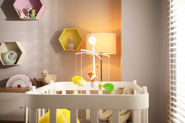Crib with baby mobile in child's room
