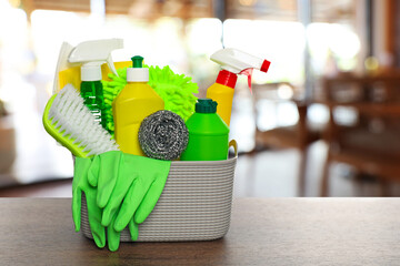 Cleaning products on wooden table in cafe. Space for text