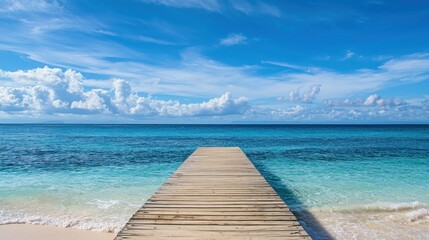 A beach pier extending into the ocean on a sunny day