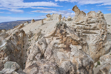 Fototapeta premium The Moon Valley Trail or Valle Lunar in Patagonia National Park, Chile. A tourist attraction with geological and landscape beauty. Unique landscape of the old rock formations of diverse colors.