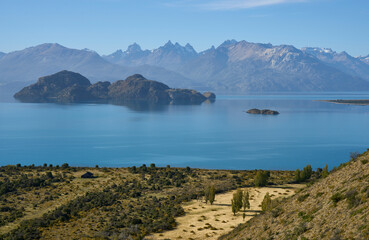The General Carerra Lake as seen from the road 7 Carretera Austral to Chile Chico. Mountains in the background. Small island in the lake. Landscape beauty, fog and haze above the lake.