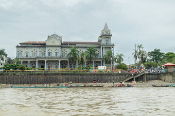 Naklejka premium Title Riverside view of Quibdó Malecon with Cathedral and riverboats 