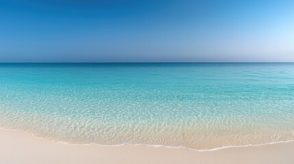 Obraz premium Beautiful view of calm sea meeting a sandy beach on a sunny day