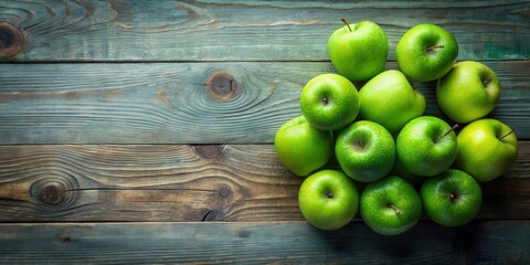 A cluster of vibrant green apples rests on a rustic wooden surface, offering a fresh and natural still life composition.
