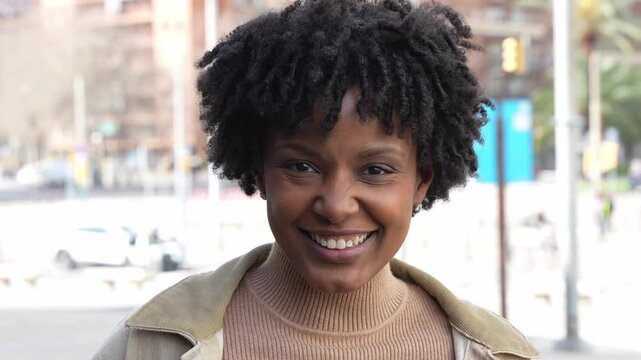 Happy afro american woman smiling at camera in city street - People life style concept  - 4k slow motion video