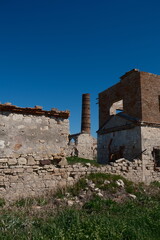 abandoned old factory with brick walls and red chimney