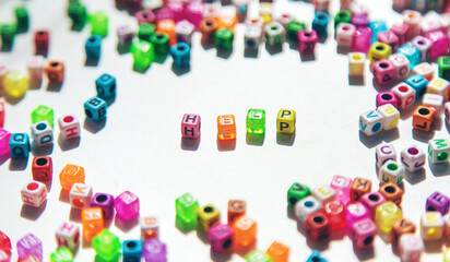 Child cubes and the word help. Selective focus.