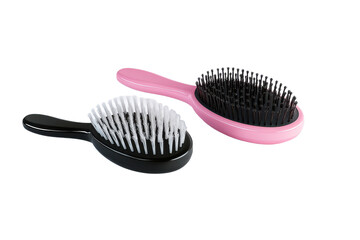 Hairbrushes for styling and detangling: pink and black brushes for hair care routine