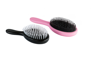 Hairbrushes for styling and detangling: pink and black brushes for hair care routine