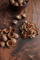 healthy nuts in the plate. nuts, walnuts and hazelnuts in the wooden table.
