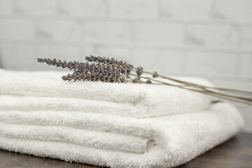 Dried lavender on white terry towels. Two white towels in the bathroom