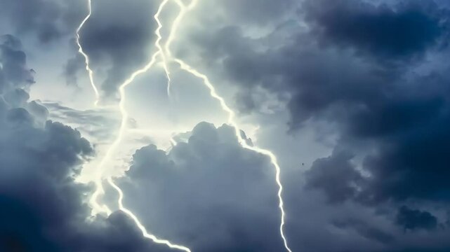 Lightning bolt cutting through dark storm clouds in a dramatic night sky capturing the raw power of nature and extreme weather conditions perfect for stock photography and natural background visuals.