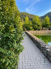 Morning reflection of the lake on the running track of a sports complex in the mountains.