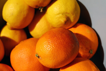 Oranges and lemons in a container.