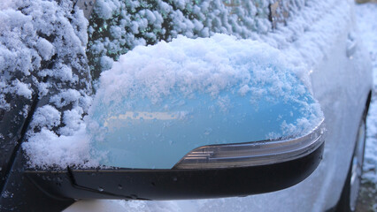 snow on the car mirror