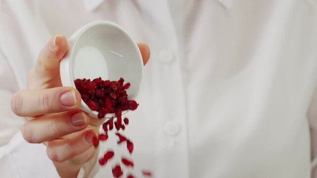 Professional chef adds paprika fragrant dry peppers to a pot of boiling food. Restaurant kitchen cooking, colorful spices, dropping spices.