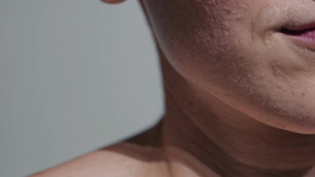Close-up video shot of a person's lower face, focusing on skin texture and natural features, captured from a straight-on angle.