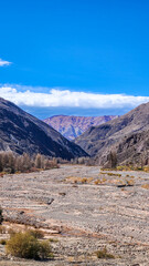 ERODED HILLS AND DRY RIVERBED IN THE QUEBRADA DE HUMAHUACA, ARGENTINA..