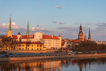 a view to Riga castle and cathedral by river Daugava in sunset light