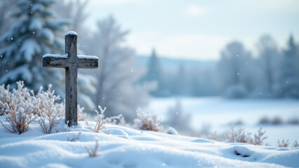A solitary cross stands tall amidst a snow-covered landscape during winter under a soft light of day.