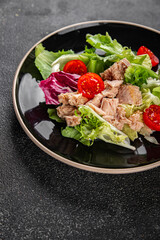 Tuna salad canned fish mixed green leaf lettuce seafood appetizer vegetable dish organic fresh tasty gourmet food background on the table rustic top view copy space vegetarian food pescetarian diet