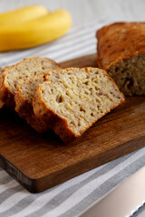 Homemade Banana Bread on a wooden board, side view.
