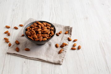 Roasted Almonds in a Bowl, side view. Copy space.