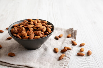 Roasted Almonds in a Bowl, side view. Copy space.