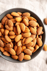 Roasted Almonds in a Bowl, top view. Flat lay, overhead, from above.