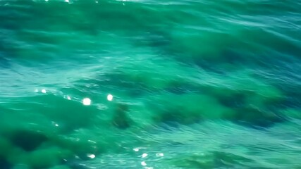 Clear turquoise sea water with sunlight reflecting on the surface creating a peaceful and vibrant natural background perfect for tropical themes, ocean textures, marine concepts, aqua summer bright.