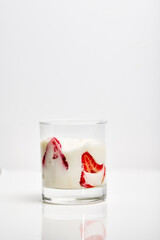 Glass of milk yogurt with fresh strawberries