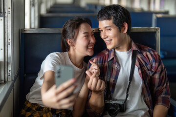 Travel and Memories. A couple captures a selfie on a train, celebrating their love and adventure.