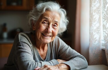 Smiling senior woman portrait in kitchen. Elderly lady looking at camera, natural light. Happy grandmother, mature beauty. Represents age, wisdom, care, family, retirement, positive outlook.