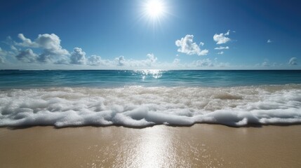 Coastal paradise with sun-drenched waves on a sandy shore. Bright blue sky, fluffy clouds, and a tranquil sea meet the beach
