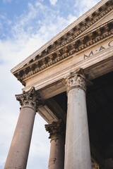 Corinthian columns supporting the ancient pantheon in rome, italy, stand tall against a backdrop of a cloudy sky, showcasing the rich history and architectural marvel of this iconic landmark