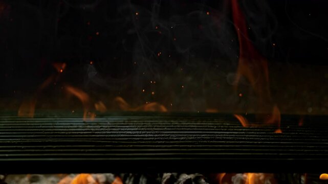Super Slow Motion Close-Up of Hot Grill Grate with Flames and Glowing Embers at 1000fps.