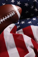 American football ball and USA flag. Sport game. Super bowl in US. Football ball Close Up macro photography with copy space.