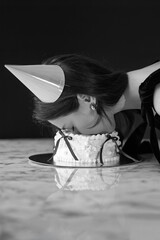 A girl with her face in the cake