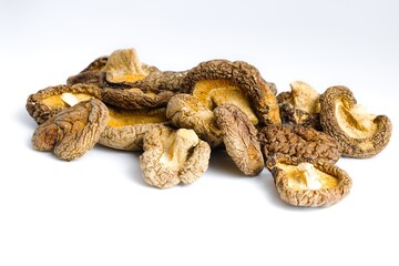 Detailed dried shiitake mushrooms arranged on a clean white surface, showcasing their authentic, natural charm.